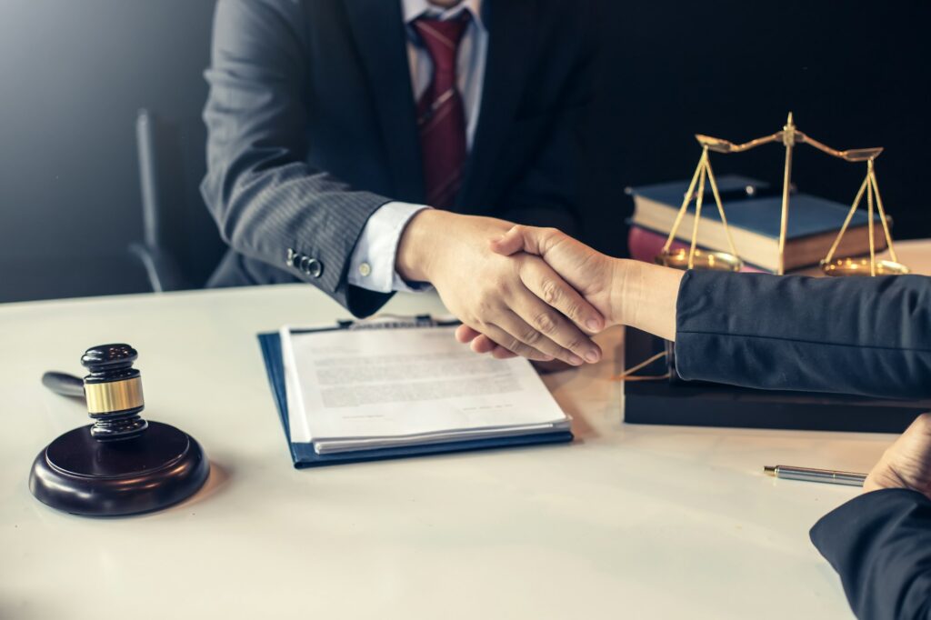 Lawyer who provides legal advice in the office. Businessman and lawyer shaking hands.