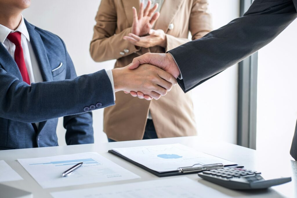 Two confident Business handshake and business people after discussing good deal of Trading contract