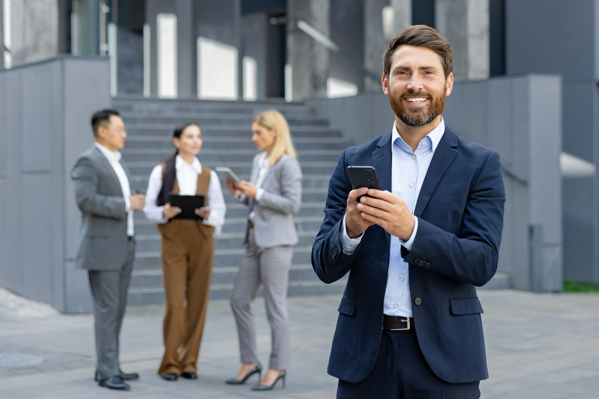 business professionals using phones outside corporate building