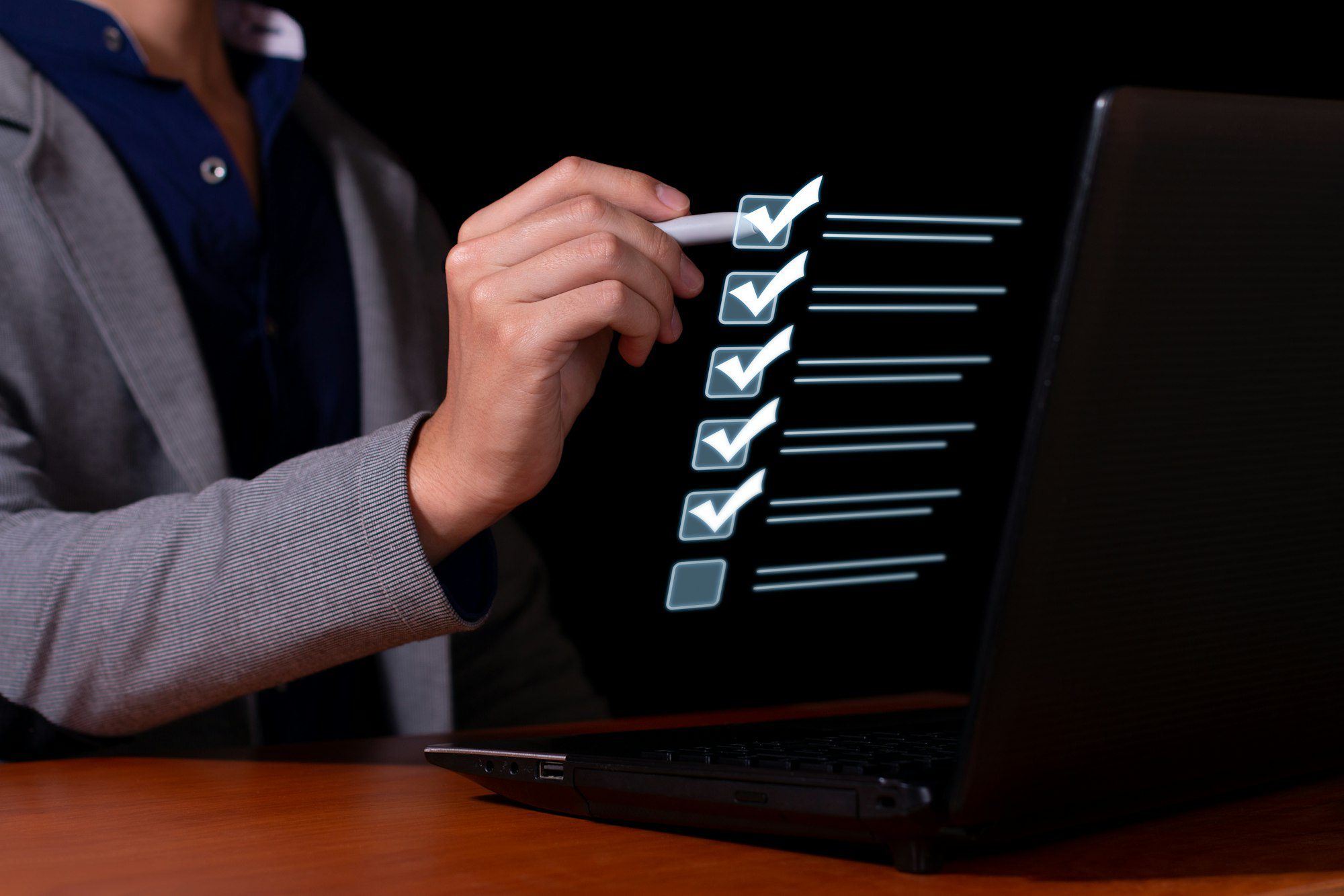 Businessman marks the checklist for document control, online product quality and business approval.