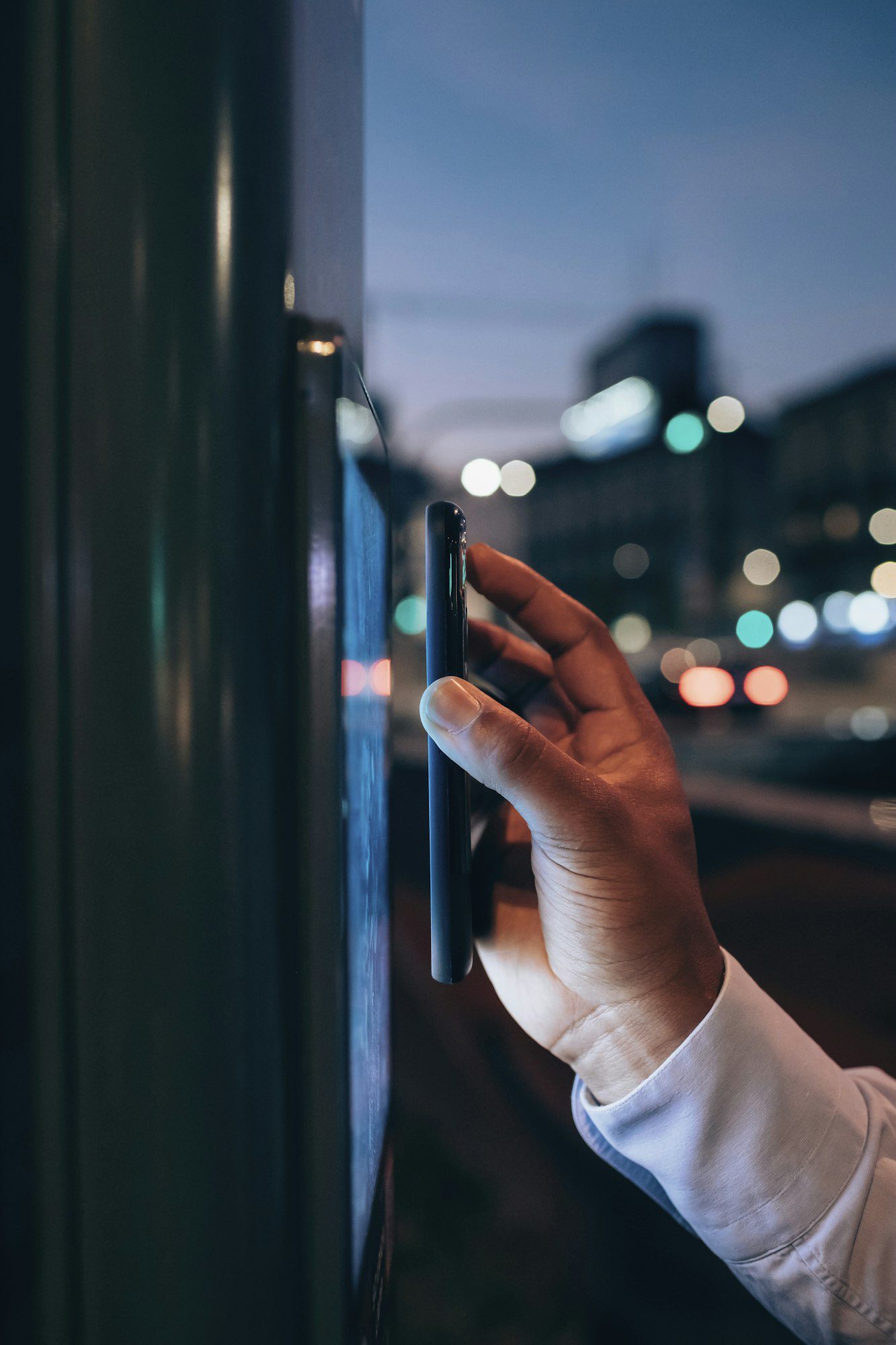 businessman using digital information system at bus stop