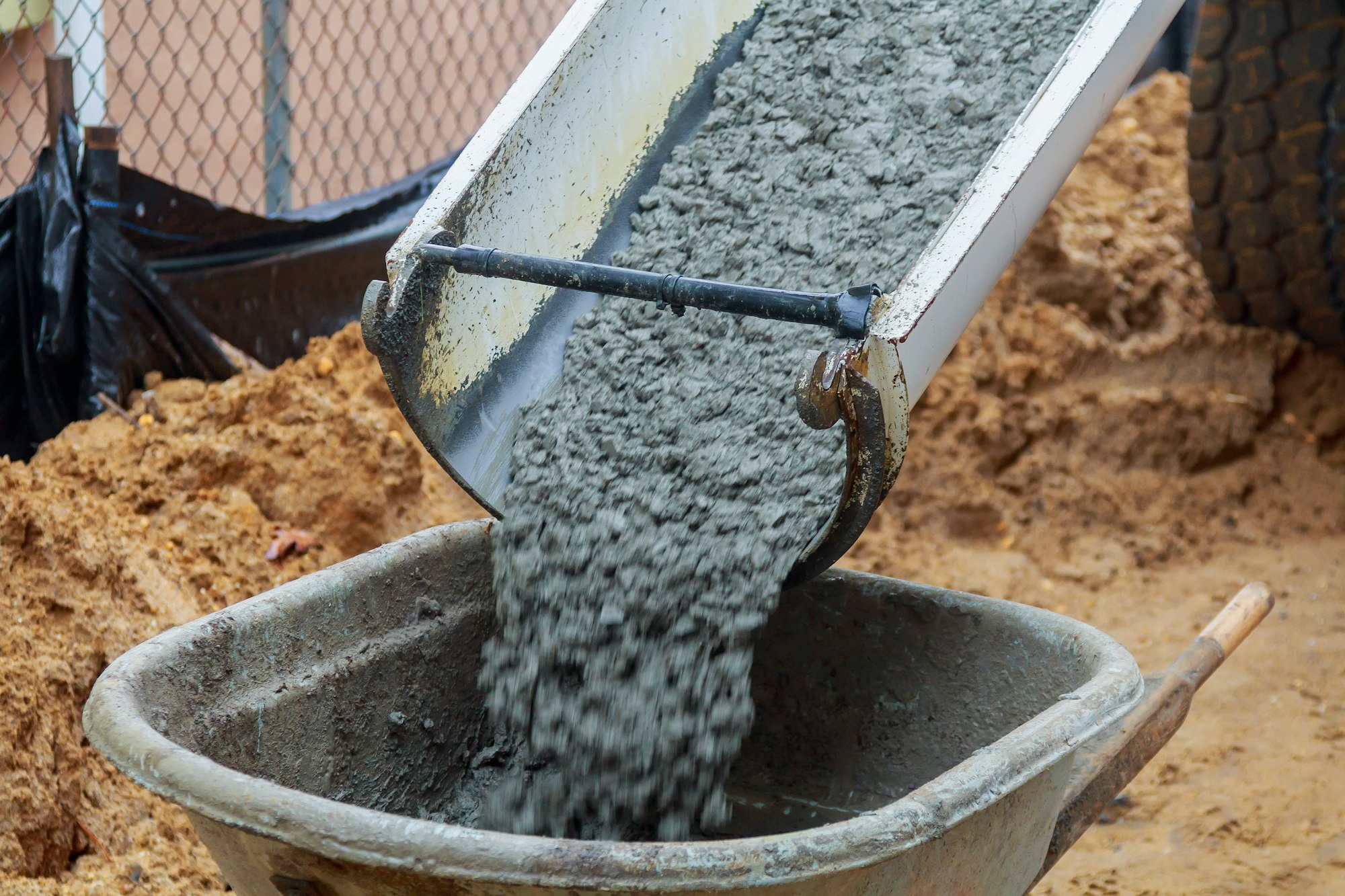 wheelbarrow with shovel full of cement concrete wheelbarrow