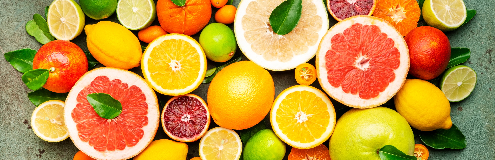 citrus fruit food background top view mix of different whole and sliced fruits