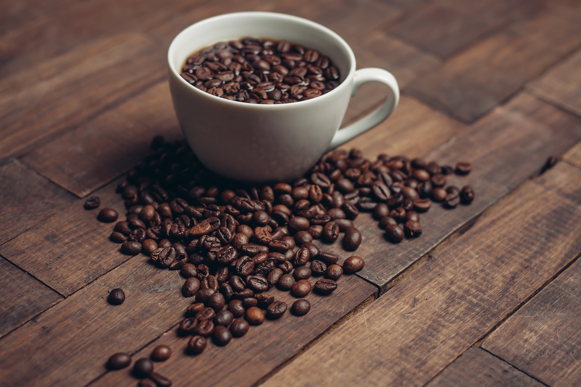 cup with coffee grains on a wooden table aromatic drink